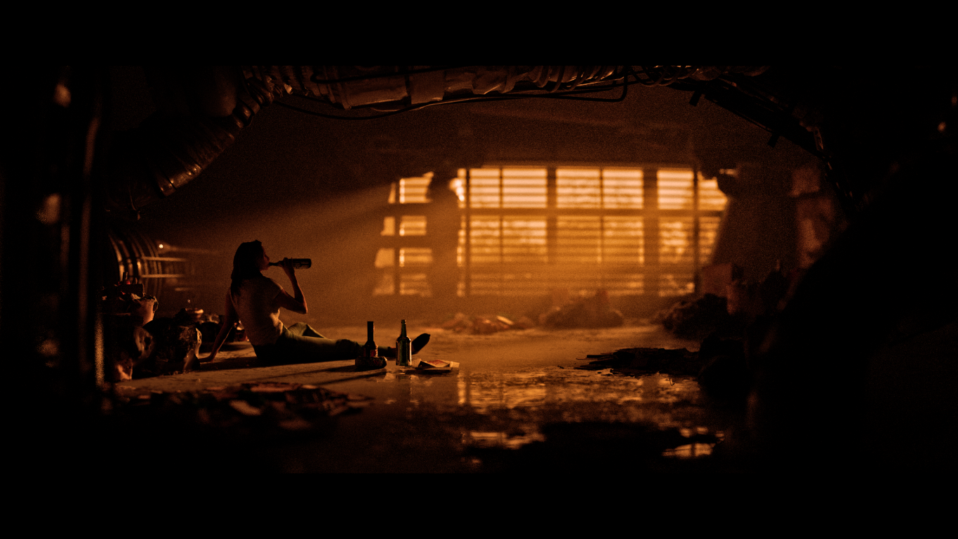 A figure in a warm, dimly lit room